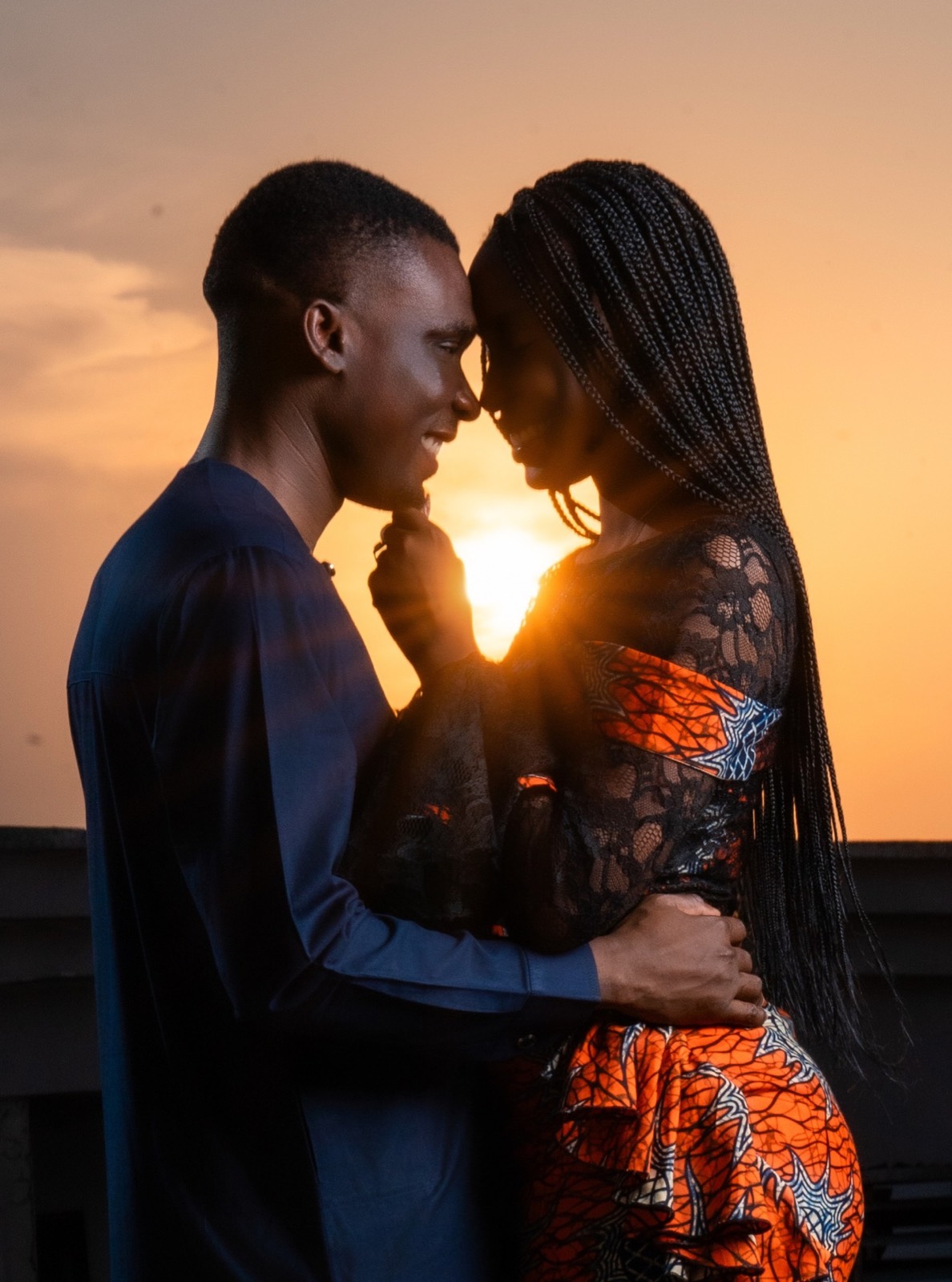 Couple at sunset, foreheads touching